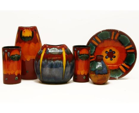 A collection of Delphis Poole pottery, to include a pair of cylindrical vases, three further vases and a plate