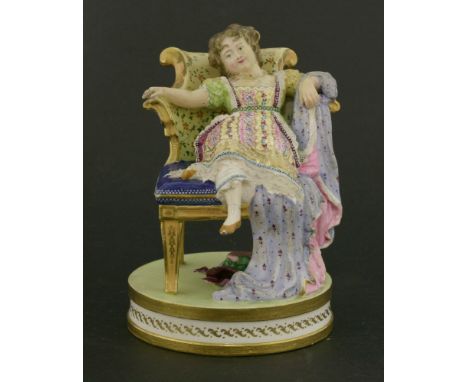 A Minton polychrome ceramic figure,of a young girl lounging on a chair, mounted on a circular gilt decorated plinth, leg crac