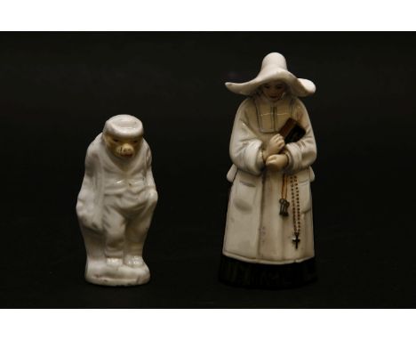 A possibly Worcester snuffer, 'the nun', in black and white habit, 9cm tall, together with a further figure in the form of a 