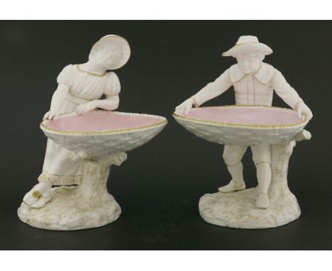 A pair of Royal Worcester figural bonbon dishes,a boy and girl with outstretched hands, holding a gilt heightened oval bowl, 