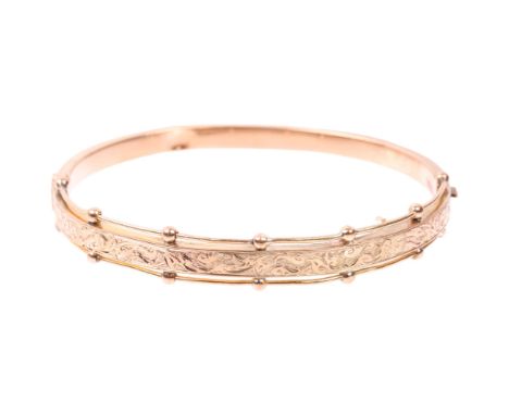 A Victorian foliate hinged bangle, maker TW, apparently unmarked but assume 9ct, band width 8.3mm, internal circumference 16c
