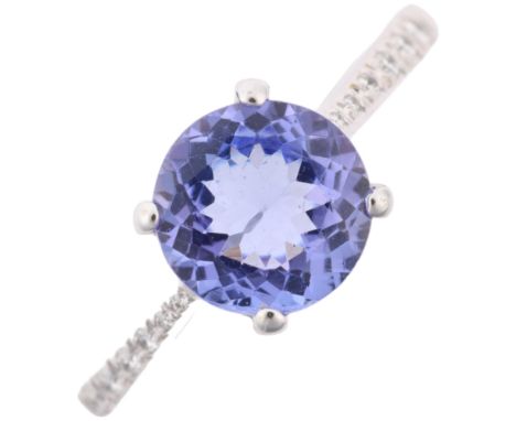 An 18ct white gold tanzanite and diamond dress ring, claw set with round-cut tanzanite and modern round brilliant-cut diamond