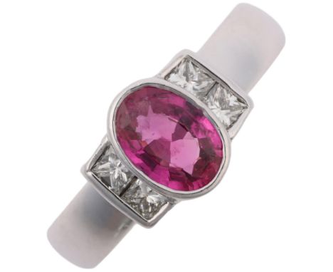 A modern 18ct white gold pink sapphire and diamond dress ring, rub-over set with 0.7ct oval mixed-cut sapphire flanked by Pri