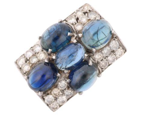 A sapphire and diamond cross cluster panel ring, in the Art Deco style, set with oval cabochon sapphires and modern round bri