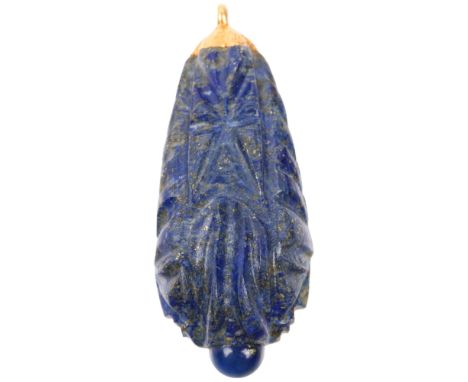 A large Ethnic carved lapis lazuli idol head teardrop pendant, with unmarked yellow metal mount, 69.3mm, 64g Condition Report