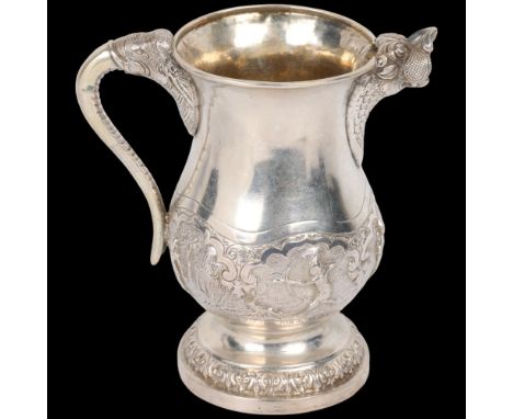 A good quality Indian silver cream jug, probably Bombay 1900, baluster form with cast lion spout, elephant handle and relief 