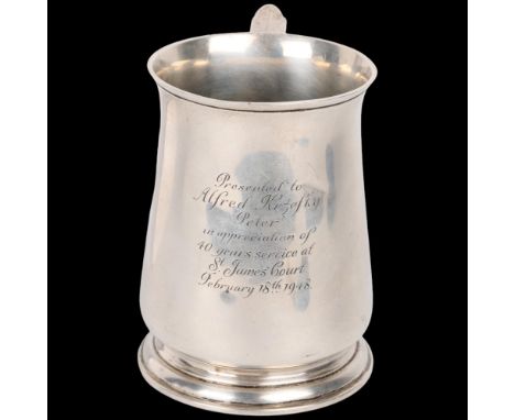 A George VI silver pint mug tankard, Harrods, London 1947, tapered cylindrical form with flared rim and a scrolled handle, 12