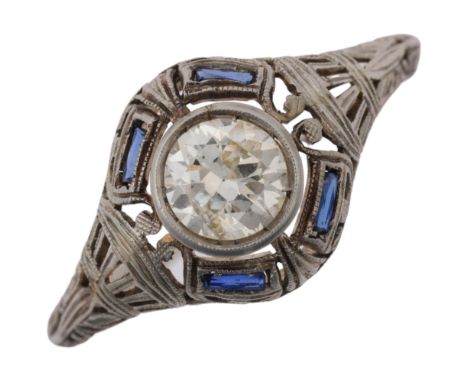 An Art Deco 0.55ct solitaire diamond ring, circa 1930, openwork scroll decoration with rectangular-cut sapphires, diamond wei