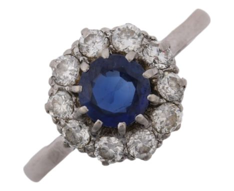 A mid-20th century platinum sapphire and diamond flowerhead cluster ring, claw set with round-cut sapphire and modern round b