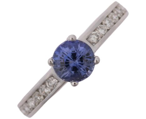 A modern 18ct white gold tanzanite and diamond ring, set with round-cut tanzanite and modern round brilliant-cut diamond shou