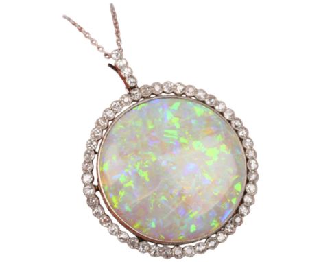 A Belle Epoque opal and diamond cluster pendant necklace, rub-over set with 15ct round cabochon opal surrounded by old-cut di