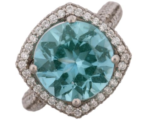 A modern platinum blue synthetic spinel and diamond halo cluster ring, pave set with modern round brilliant-cut diamonds, set