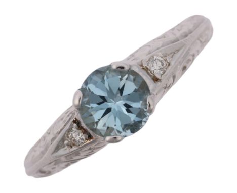 A modern 18ct white gold aquamarine and diamond dress ring, in Art Deco style, claw set with 0.7ct round-cut aquamarine and m