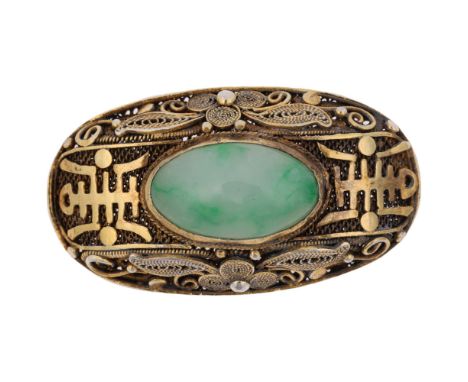 A Chinese silver-gilt jade bombe brooch, oval form with applied character marks on filigree wirework ground set with oval cab