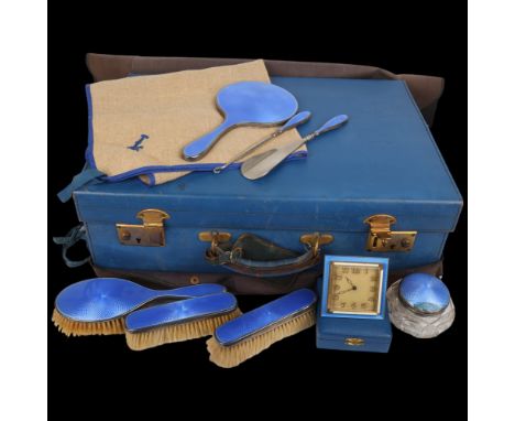 An Art Deco George V blue leather travelling vanity case, containing the original silver and blue enamel dressing table set, 