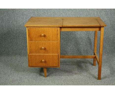A mid century Meredew Furniture dressing table in light oak fitted with a rising vanity mirror. H.68 W.92 D.50cm. 