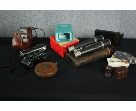 A collection of photographic and cinematic equipment and binoculars. Includes a Minolta Pocket camera, an Autopak 460 T camer