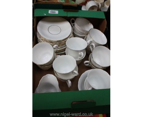 A quantity of white and gilt cups and saucers, various styles.