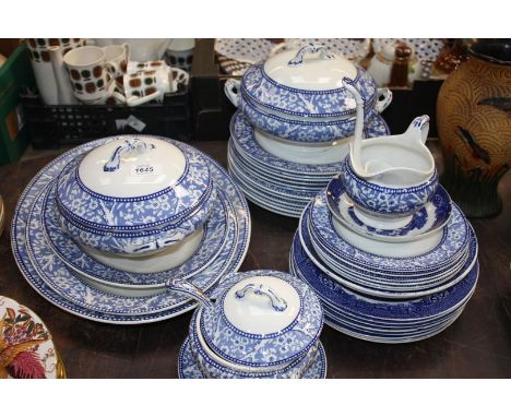 A part Wedgwood blue and white Dinner service including two vegetable tureens and lids, three graduated meat plates, six larg
