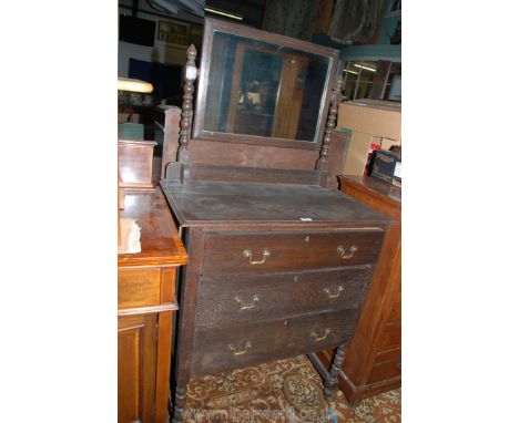 A 1940's Oak Dressing Chest having rectangular mirror in bobbin turned supports, moulded edge top over flight of three gradua