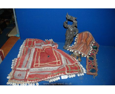 Three pieces of Indian Textiles, a wind chime and a Spelter figure of a Standard Bearer