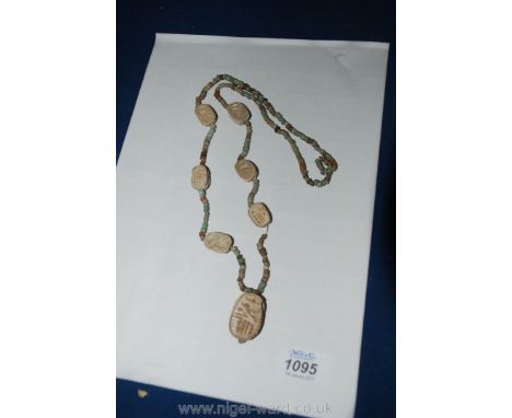 An Egyptian ceramic Bead Necklace with seven scarabs, 16 1/2'' long.