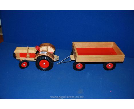 A wooden Tractor with a wooden tipping Trailer.
