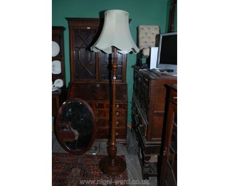 A Georgian style Mahogany Standard Lamp, having turned column with reeded urn base, on circular moulded dish platform with ro