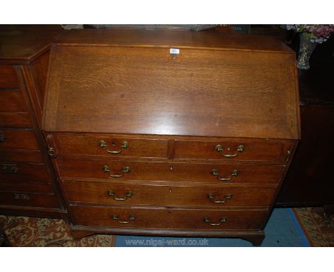 A good 19th c. Oak Bureau, having plain top over cleated edge fall opening to reveal four pigeon holes, central small cupboar