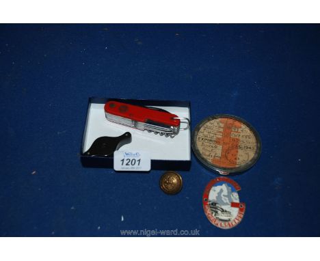 A Swiss penknife, Grossglockner Enamel Badge, three lens loop and an old Tax disc 1943