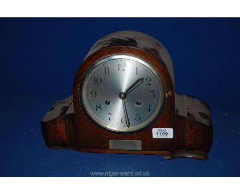 A circa 1930 Oak cased presentation Mantle Clock having dome top and moulded sides to the case, ''Presented to Mr. L. Roberts