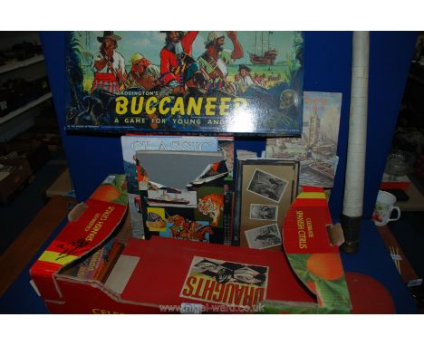 A box of games and books including Draughts, Monopoly, Manchester United Encylopeadia classic sports and super cars,  telesco