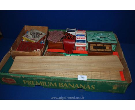 A quantity of packs of playing Cards, wooden jigsaws, travel games, cribbage boards, etc.