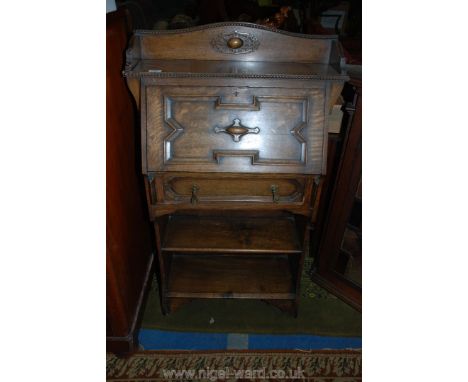 A 1920's Oak Student's Bureau having moulded back with geometric moulding bead moulded edge to over the Jacobean style moulde
