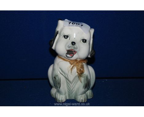 A pretty novelty ceramic tape measure c. 1920, modelled as a puppy.