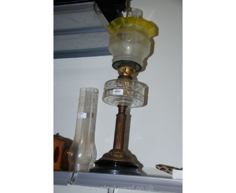 A Victorian Oil Lamp with clear glass reservoir and etched coloured glass shade, with spare chimney.