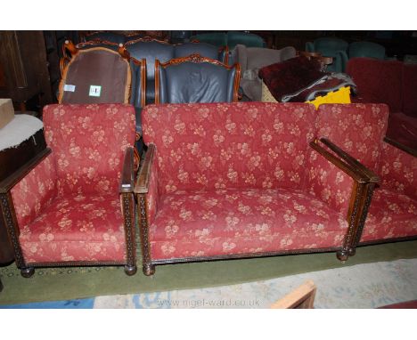 A 1920's Oak framed three piece Lounge Suite comprising two seater sofa and two matching armchairs, having flat tapering moul