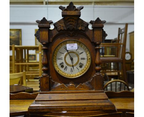 American oak cased mantel clock, circa 1900, architectural case with carved decoration, Ansonia movement, striking on a gong,