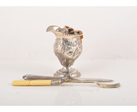 George III silver helmet shape cream jug, marks rubbed, decorated with scrolls and flowers, 11cm, six tea knives with stainle