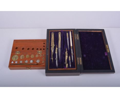 Geometry set in a stained rosewood case, width 19cm, a set of metric weights in a mahogany case and a Victorian box, (3).