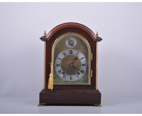 Mahogany mantel clock, arched brass dial with silvered chapter ring and slow fast dial, movement striking on two gongs, 31cm.