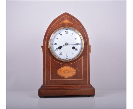Mahogany lancet shape mantel clock, inlaid decoration, white enamel dial, movement striking on a gong, 36cm.