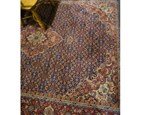 Tabriz pattern carpet, central medallion, patterned blue field, scrolled spandrels, border within guards, 280cm x 205cm.