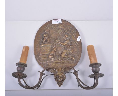 Two bronzed two light wall brackets, oval plaques, modelled with a maiden, adorning statue of Cupid, height 31cm.