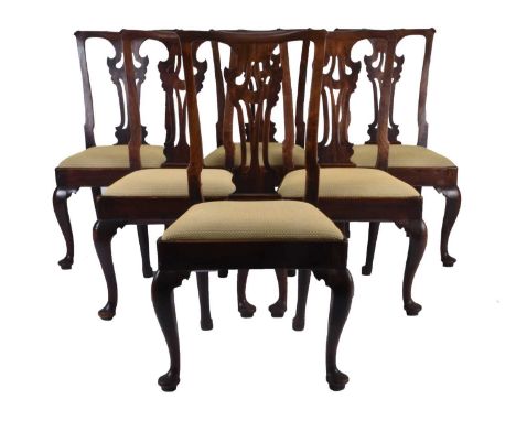 A set of six George III mahogany dining chairs, in the Chippendale style, with shaped top rail above a carved and pierced spl