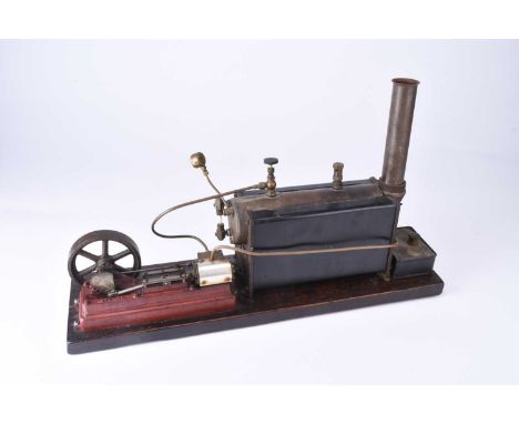 A Stuart Turner model stationary steam engine, with horizontal boiler and a single cylinder engine with flywheel, mounted on 
