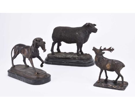Three bronze figures of animals, 20th centuryThe first modelled as a standing ram, 19cm high, the second a hunting dog clutch