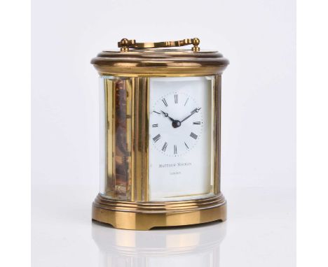 A Matthew Norman gilt brass carriage timepieceWith oval four-glass case, the white enamel dial with black Roman numerals, the