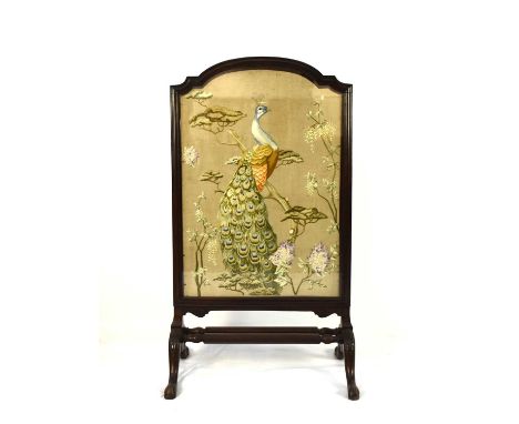 A Victorian mahogany and embroidered firescreenThe shaped moulded screen frame enclosing a wool embroidery of a peacock perch