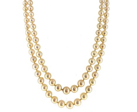 two rows of graduating light cream, slightly off-round cultured pearls, graduating from 4 to 7.7mm, strung knotted to a flora
